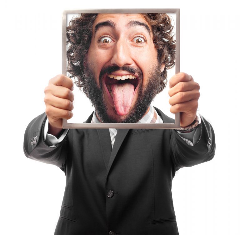 A Man hiding behind a frame that shows him looking crazy